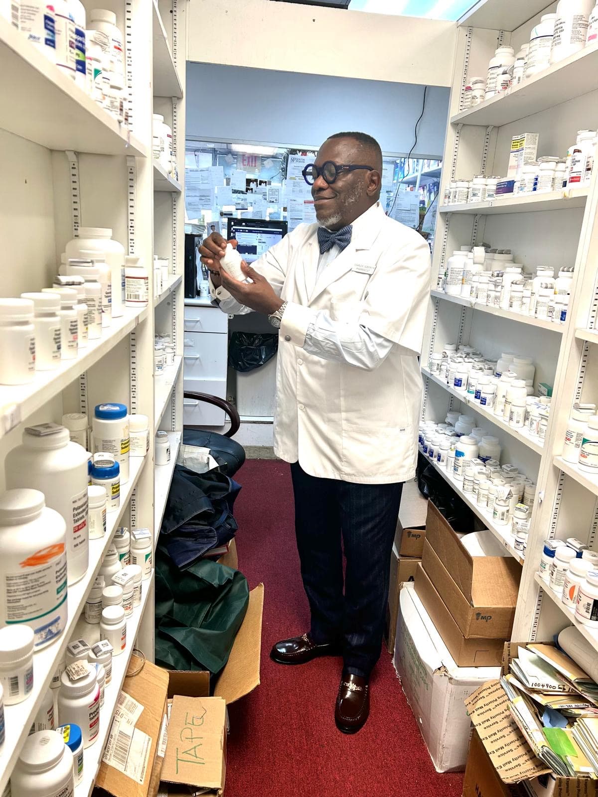 Pharmacist Charles Ikenna Ezeonyim preparing a prescription at Restoration Pharmacy